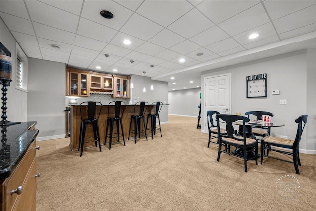 dining area with light carpet, baseboards, a dry bar, and recessed lighting