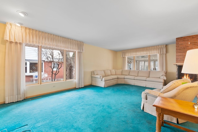 living area with carpet, a fireplace, visible vents, and baseboards