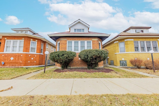 bungalow-style home featuring brick siding