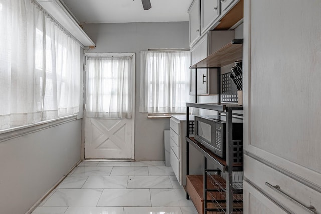 kitchen with ceiling fan and marble finish floor