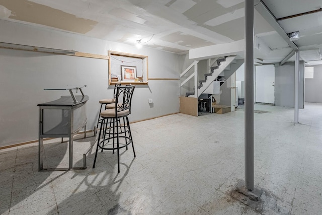 finished basement featuring tile patterned floors and stairs