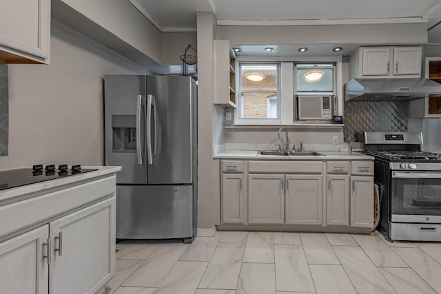 kitchen featuring appliances with stainless steel finishes, a sink, light countertops, under cabinet range hood, and backsplash