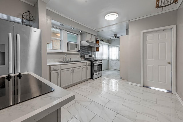 kitchen featuring ceiling fan, appliances with stainless steel finishes, marble finish floor, under cabinet range hood, and a sink