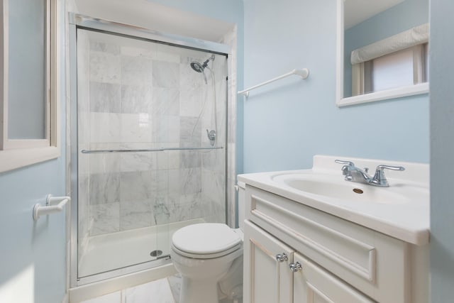 full bathroom featuring vanity, toilet, and a stall shower