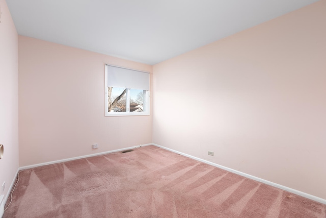 unfurnished room with baseboards and carpet floors