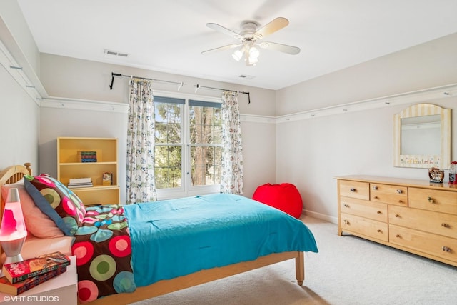 bedroom with baseboards, carpet floors, visible vents, and a ceiling fan