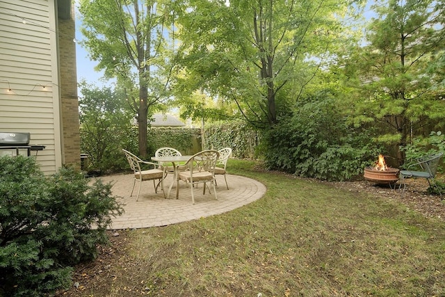 view of yard with an outdoor fire pit, a patio, and fence