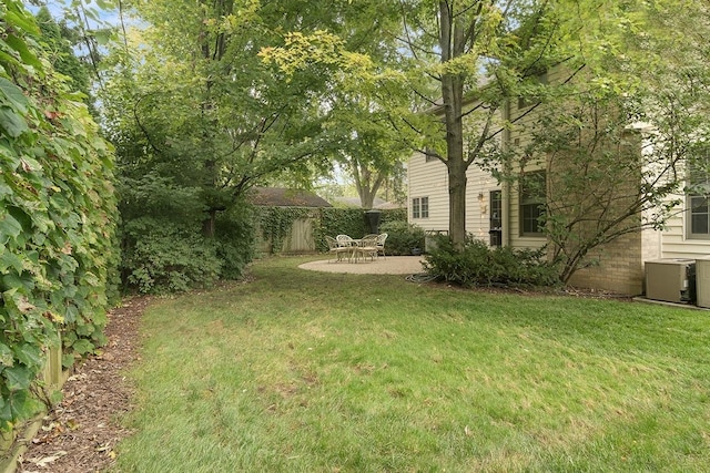 view of yard with central AC, a patio, and fence