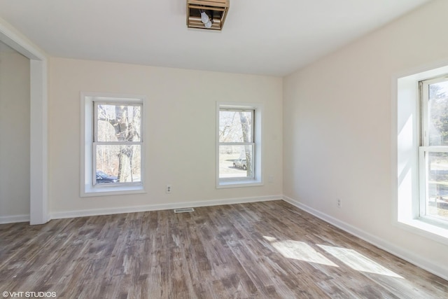 1803 Guion St, Ottawa, IL 61350 - empty room featuring wood finished floors, baseboards, and visible vents