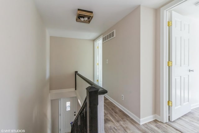 1803 Guion St, Ottawa, IL 61350 - hallway with light wood-style flooring, an upstairs landing, visible vents, and baseboards