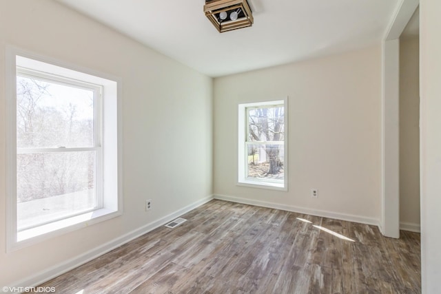 1803 Guion St, Ottawa, IL 61350 - empty room with visible vents, baseboards, and wood finished floors