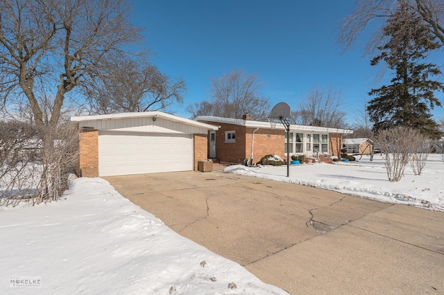 view of front of property featuring concrete driveway, brick siding, a chimney, and an attached garage