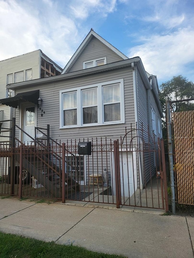 view of front facade featuring a fenced front yard and a gate