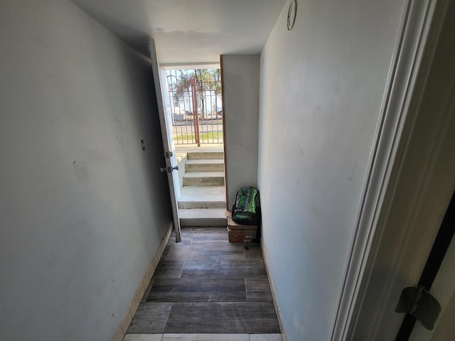 entryway featuring baseboards and wood finished floors