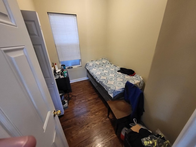 bedroom with dark wood-style floors