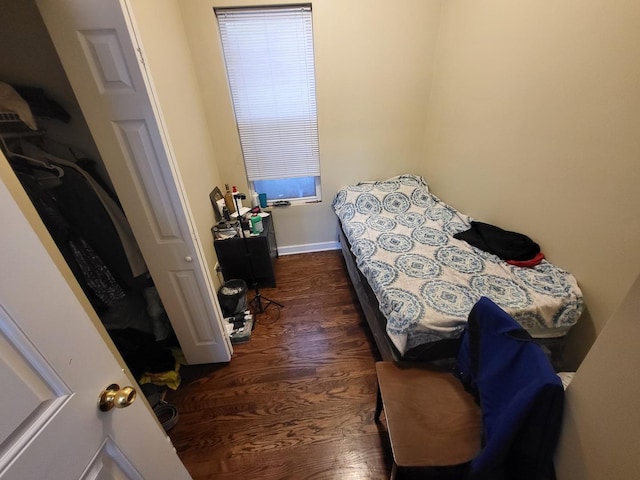 bedroom featuring dark wood finished floors