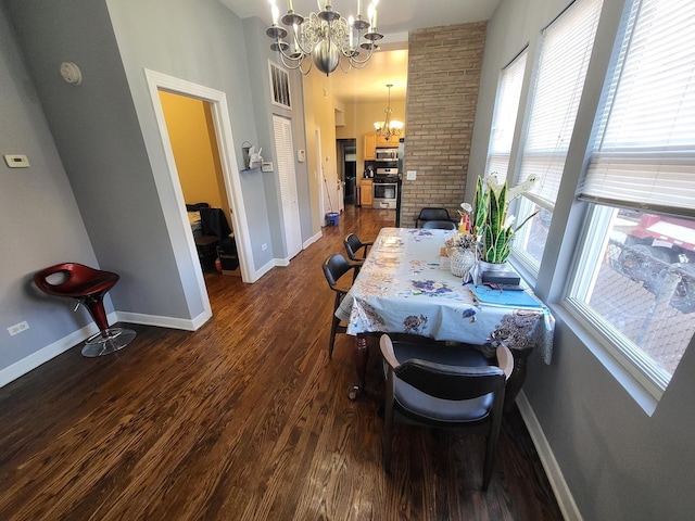 dining room featuring baseboards, dark wood-style flooring, and a notable chandelier