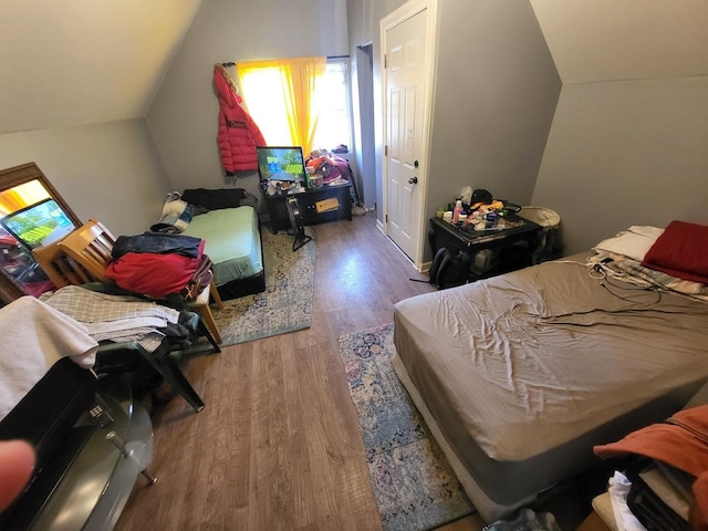 bedroom featuring vaulted ceiling and wood finished floors