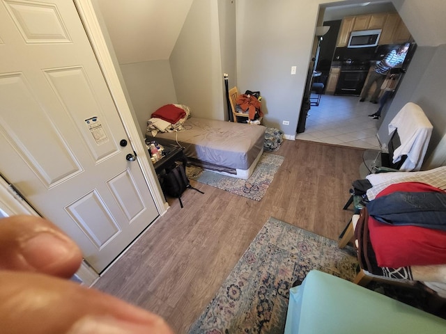 bedroom with light wood finished floors and baseboards