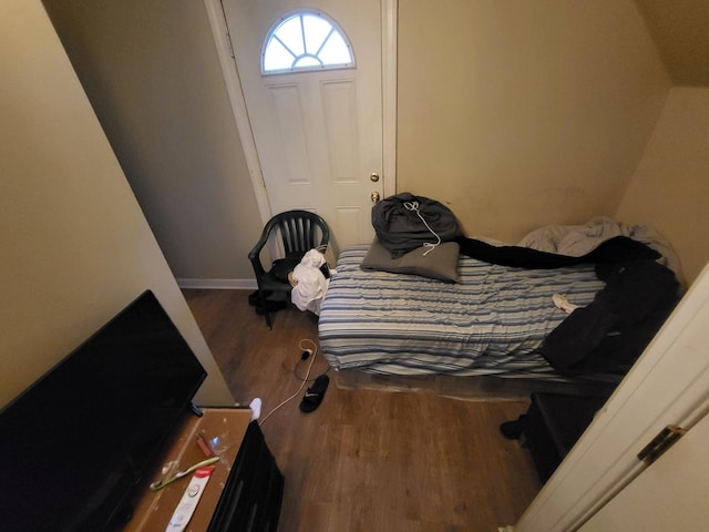 bedroom with baseboards and wood finished floors