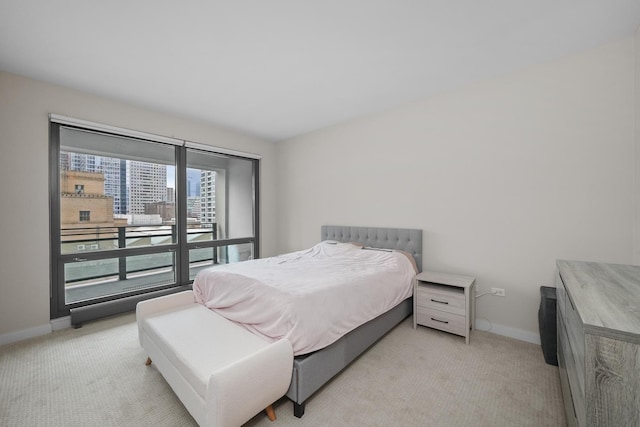 bedroom featuring baseboards and light colored carpet