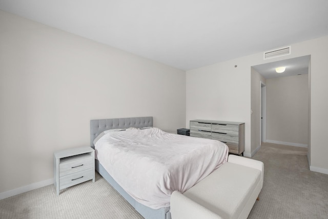 bedroom featuring light carpet, baseboards, and visible vents