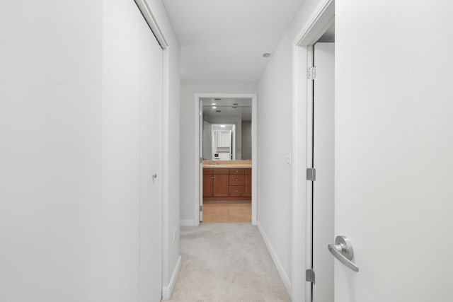 hall with light carpet and baseboards