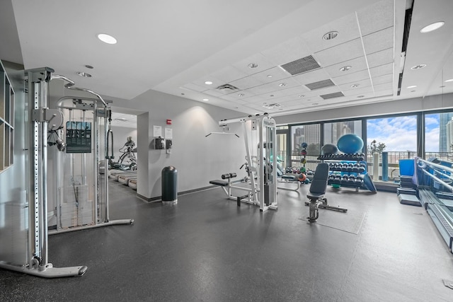 gym featuring a drop ceiling, visible vents, and baseboards