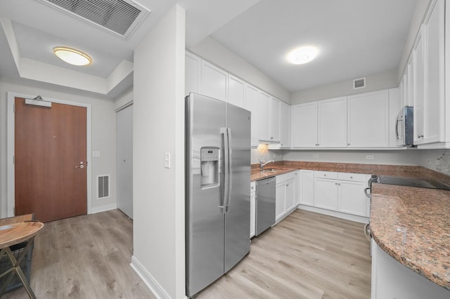 kitchen featuring appliances with stainless steel finishes, light wood-type flooring, and visible vents