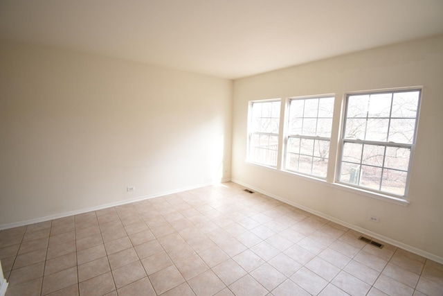 empty room featuring visible vents and baseboards