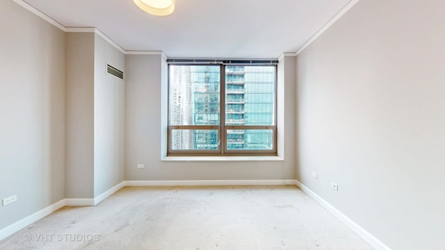 carpeted empty room with baseboards, visible vents, and crown molding