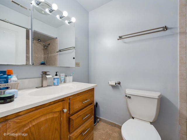 full bathroom featuring vanity, baseboards, a shower, tile patterned floors, and toilet