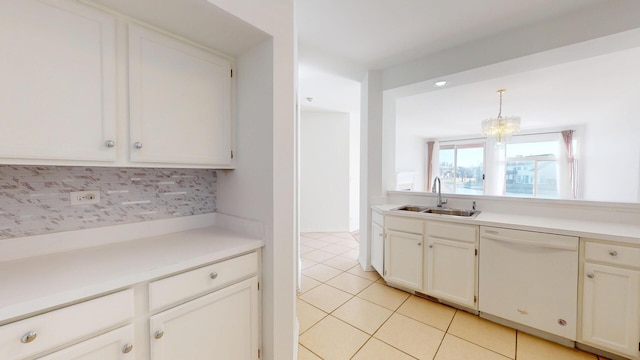 kitchen featuring a sink, backsplash, light countertops, light tile patterned floors, and dishwasher