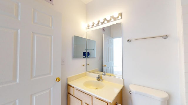 bathroom featuring toilet and vanity