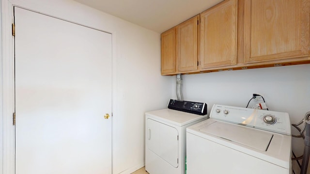 laundry area with cabinet space and independent washer and dryer