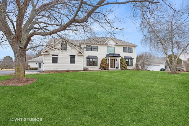 view of front of home featuring metal roof, a front lawn, and a standing seam roof