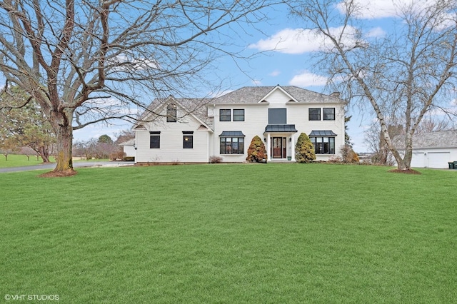 view of front of home featuring a standing seam roof, a chimney, a front yard, and metal roof