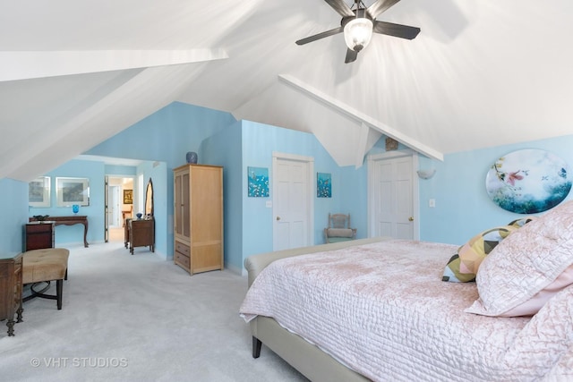 carpeted bedroom featuring a ceiling fan and vaulted ceiling