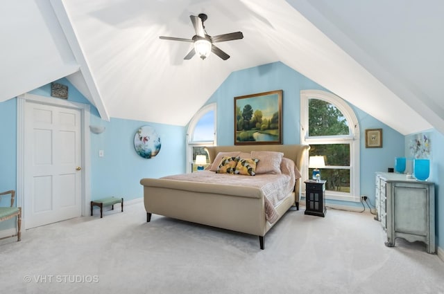 carpeted bedroom with lofted ceiling, ceiling fan, multiple windows, and baseboards