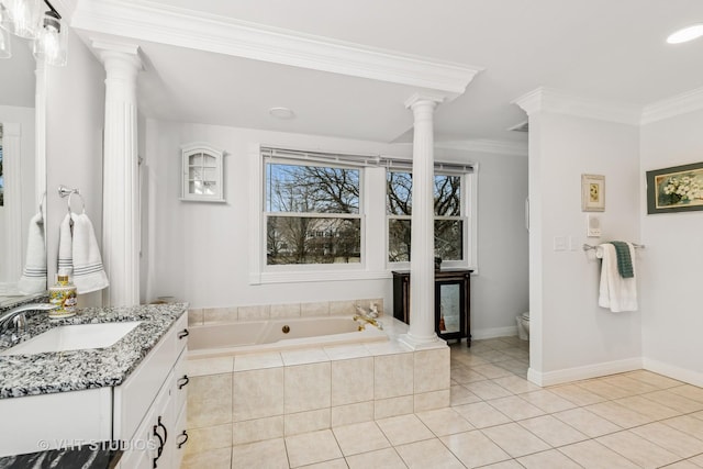 bathroom featuring a garden tub, decorative columns, crown molding, and tile patterned floors