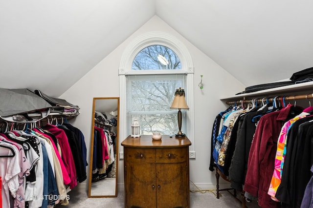 walk in closet featuring vaulted ceiling and carpet floors