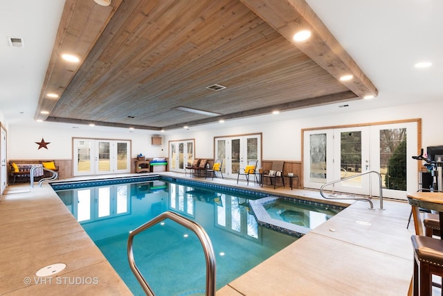 view of pool with a pool with connected hot tub and french doors