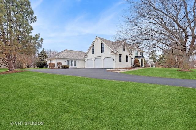 view of side of home with a garage, driveway, and a lawn