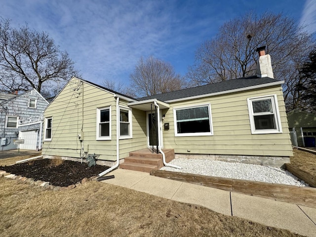 view of front of home featuring a chimney