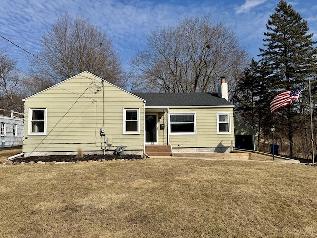 view of front of house with a front lawn and a chimney