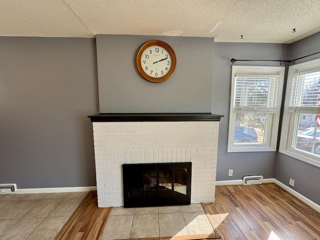 details with a fireplace, baseboards, and wood finished floors