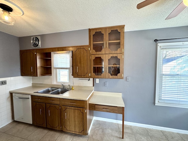 kitchen with open shelves, light countertops, visible vents, a sink, and dishwashing machine