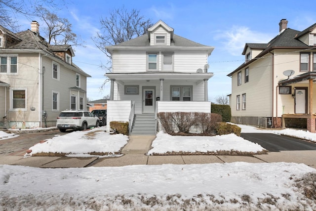 american foursquare style home with a porch