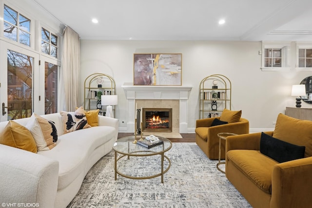 living area featuring baseboards, a tiled fireplace, wood finished floors, and recessed lighting