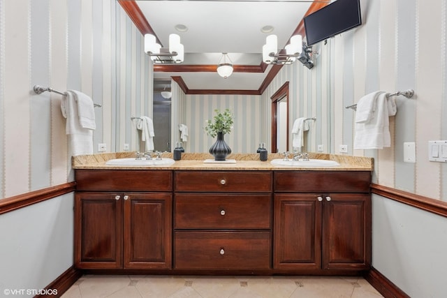 full bath featuring double vanity, a sink, baseboards, and wallpapered walls